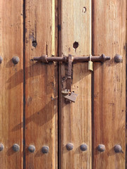 Old wooden background with old iron latch and various padlocks. Tropical construction. Martinique. French West Indies