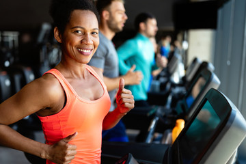 Happy woman smiling and working out in gym