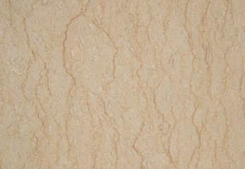 The texture of beige marble with vertical curved stripes. Granite of color of baked milk with gyrus. Not an ordinary background.