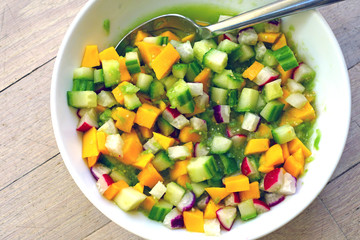 Bowl of fresh salsa with mango, radish, cucumber and tomatillo