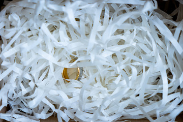 The rings are in scraps of paper that are cushioned and prepared to be delivered to the customer