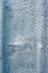 The old surface is painted with silver oil paint. Close-up. Texture. Abstract background