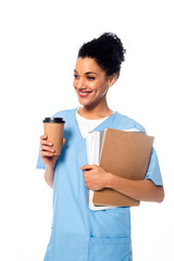 Happy and positive african american nurse with papers and disposable cup of coffee isolated on white