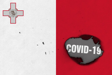 Flag of Malta with burned out hole showing Coronavirus name in it. 2019 - 2020 Novel Coronavirus (2019-nCoV) concept, for an outbreak occurs in Malta.
