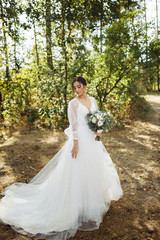 Beautiful bride on sunset in the forest