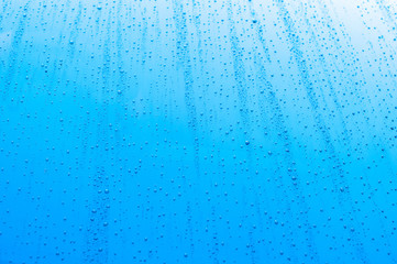 Naklejka na ściany i meble Close up of water drops on background. Abstarct texture with bubbles on window glass surface. Raindrop, Realistic pure water droplets condensed for creative banner design