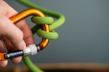 hand holder orange carabiner green rope clove hitch