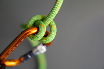 Green rope clove hitch carabiner closeup