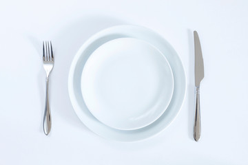 empty plate with fork and knife isolated on white