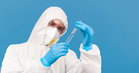 Scientist in the laboratory with test tube and virus. Looking for a vaccine for Coronavirus...