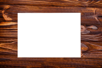 Fototapeta premium Empty sheet of paper on a wooden background. Flatfly