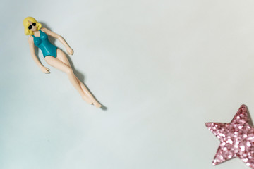 Plakat beautiful swimsuit Women plastic toy top view on blue background