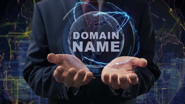 Male hands activate a conceptual holographic text Domain name. Businessman in a suit with a hologram of planet Earth on a background of a futuristic wireframe city