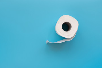Toilet paper rolls on blue background. Copy space