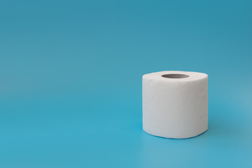 Toilet paper rolls on blue background. Copy space