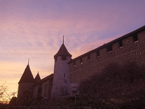 Medieval City Walls with Wall Towers in Murten or Morat in Switzerland at sunset.