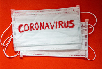Concept of a coronavirus pandemic.Medical Disposable Face Mask with covid-19 printed on it....