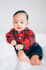 Happy 4 month baby. Little boy in a red shirt. Children portrait. Stylish baby in fashionable.