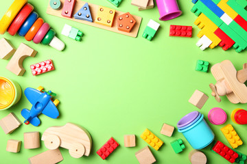 Set of different children's toys on a colored background top view. A place to insert text, minimalism. Baby background.