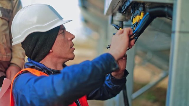 Worker checking solar cell system. Engineer checks the electrical box in the solar photovoltaic area