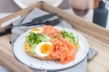 Sandwich with toast bread, smoked salmon, cream cheese, sliced cucumber and boiled eggs