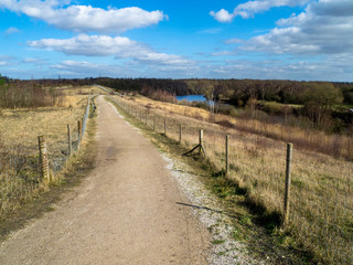 Path through Fairburn Ings Nature Reserve, West Yorkshire, England, with a view of the River Aire