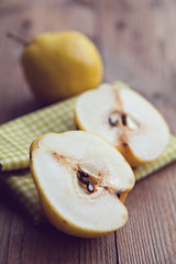 Closeup sliced ripe pear on wooden background