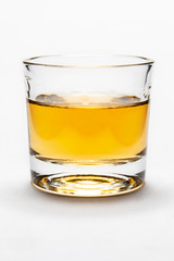 Studio shot of rum on white background in shot glass