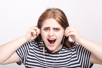 aggressive teenager listening to loud music with earphones