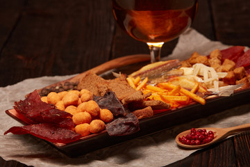 Glass with beer and snacks