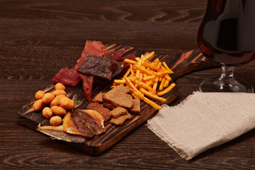 Glass with beer and snacks