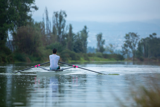 rowing men on lake