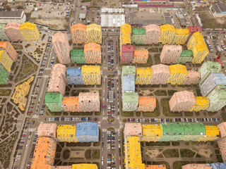 Fototapeta premium Colorful houses in Comfort Town district in Kyiv at cloudy weather, multi-floor apartment buildings complex. Aerial panoramic drone photo, 17 March 2020.