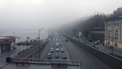 A city covered in fog. City traffic, aerial view