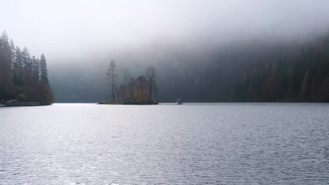 Mountain alpine autumn misty morning lake Konigssee, Schonau am Konigssee, Berchtesgaden national park, Bavaria, Germany. Picturesque traveling, seasonal and nature beauty concept scene.