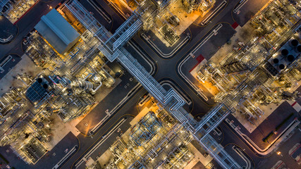 Aerial top view oil and gas tank with oil refinery background at night, Business petrochemical...