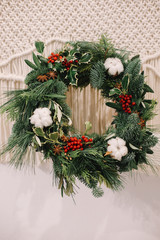 Base for Christmas wreath. Christmas decorations. Christmas wreath. Florist making Christmas wreath. View of female hands holding a wreath.