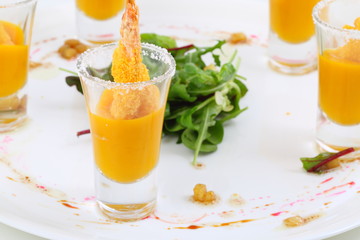 Shrimp in breadcrumbs with mango sauce on a white plate