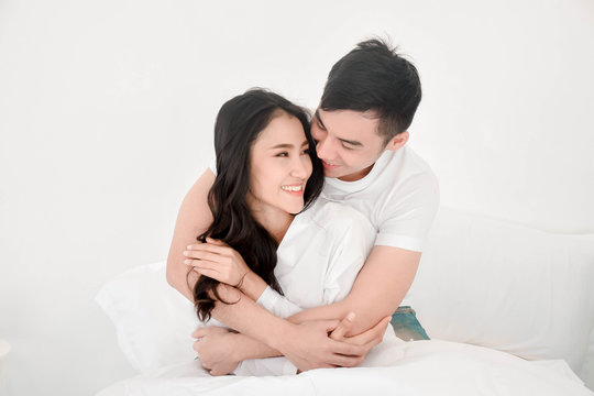 happy asian love couple in bed