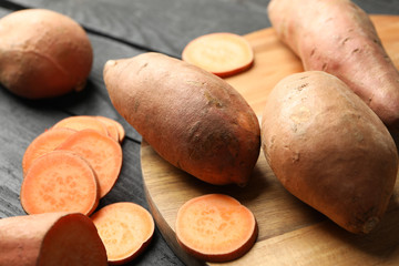 Sweet potato on wooden background, close up. Vegetables