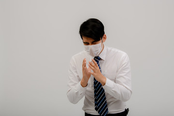 An Asian male patient wears a surgical mask on his face to help prevent virus infection and prevent the Covid-19 virus from preventing the spread of health care concepts.