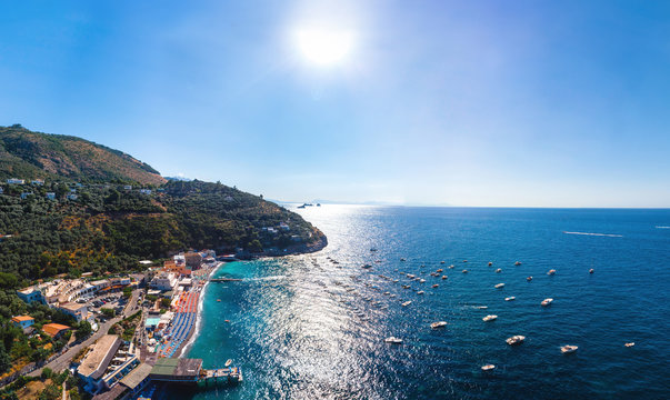 Aerial wide panorama view of coastline of the village of Nerano. Private and wild beaches. Blue surface of the water. Vacation and travel concept. Boats in bay. Copy space. For print wallpapers