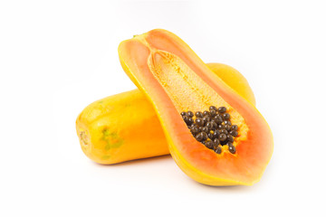 Whole and half of ripe papaya fruit with seeds on white background