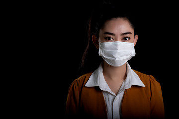 Businesswoman of young Asia woman putting on a respirator N95 mask to protect from airborne respiratory diseases as the flu covid-19 coronavirus PM2.5 dust and smog, Safety virus infection concept