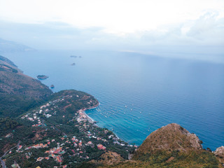 Top of the mountain, aerial view of coastline of the village of Nerano, south Italy shore. Paradise bay. Blue surface of the water, sky and sea. sunset time Vacation and travel concept. Copy space