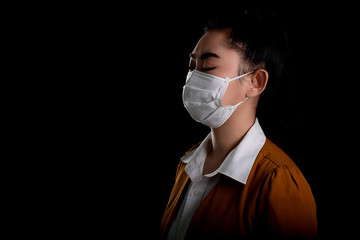 Businesswoman of young Asia woman putting on a respirator N95 mask to protect from airborne...