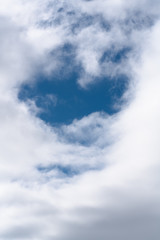 White fluffy clouds on a background of blue sky, soft focus.