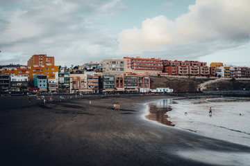 Fototapeta na wymiar Village with colorful houses and beach with black sand in Gran Canaria, Canary islands, Spain