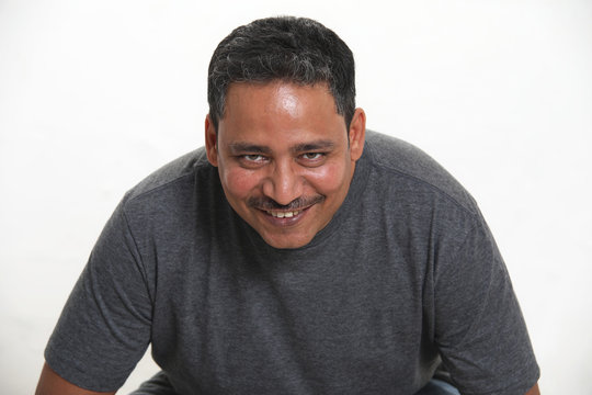 An Indian Man In A Studio Against A White Background