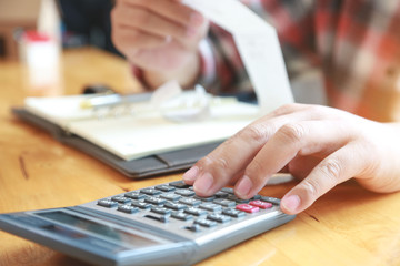 Fototapeta premium businessman using calculator and holding bill for calculate tax in office.